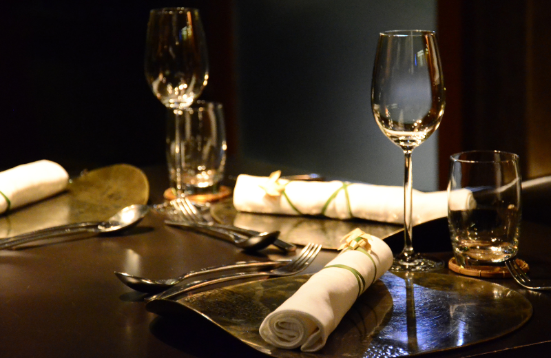 fine dining restaurant dimply lit with wine glasses